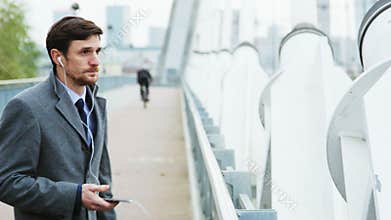 Young businessman being outdoors and frustrated during a phone call
