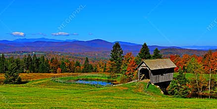 19th Century covered bridge in rolling green mountains of Vermont HDR.