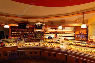 Inside bakery with saleswoman behind counter