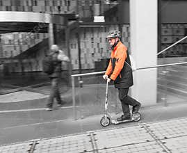 Worker in Hi-Vis Commutes on Scooter