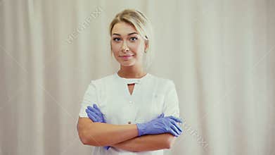 The girl in a medical overall white coat looking straight and smiling