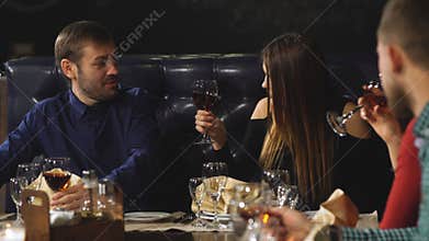 Friends at a restaurant drinking wine.