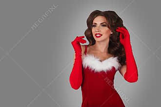Portrait of young, and beautiful woman in christmas dress. Grey background. Christmas, xmas, x-mas and winter concept.