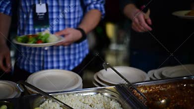 Picking food from buffet at the conference