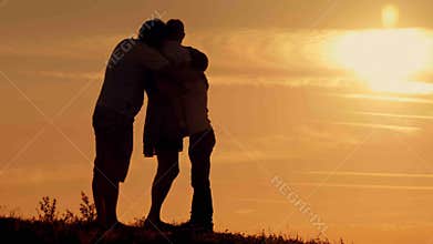 Happy family on sunset silhouette