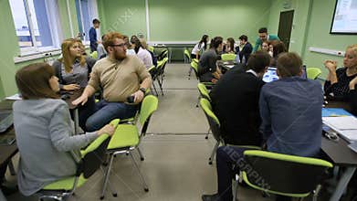 Important practical lesson in business school. Large number of students divided into groups studying information from