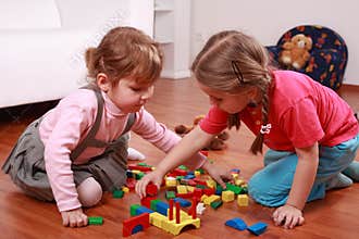 Adorable kids playing with blocks