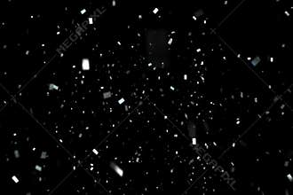 Falling silver metallic glitter foil confetti, animation movement on black background, holiday and festive fun