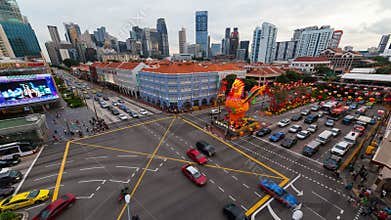 Timelapse of auto and foot traffic at a busy junction in Chinatown in Singapore Chinese New Year 4k