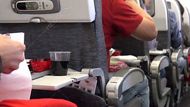 People eating the airline food during a flight
