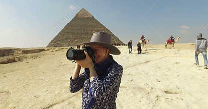 closeup of woman taking photos at Giza pyramids complex
