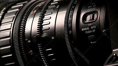 Professional camcorder lens on dark background, macro