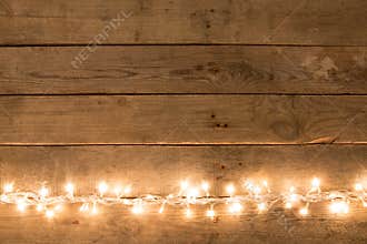 Christmas rustic background - vintage planked wood with lights and free text space