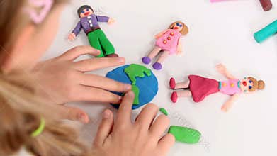 Little girl playing with plasticine